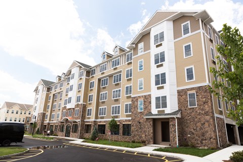a large apartment building with a street in front of it