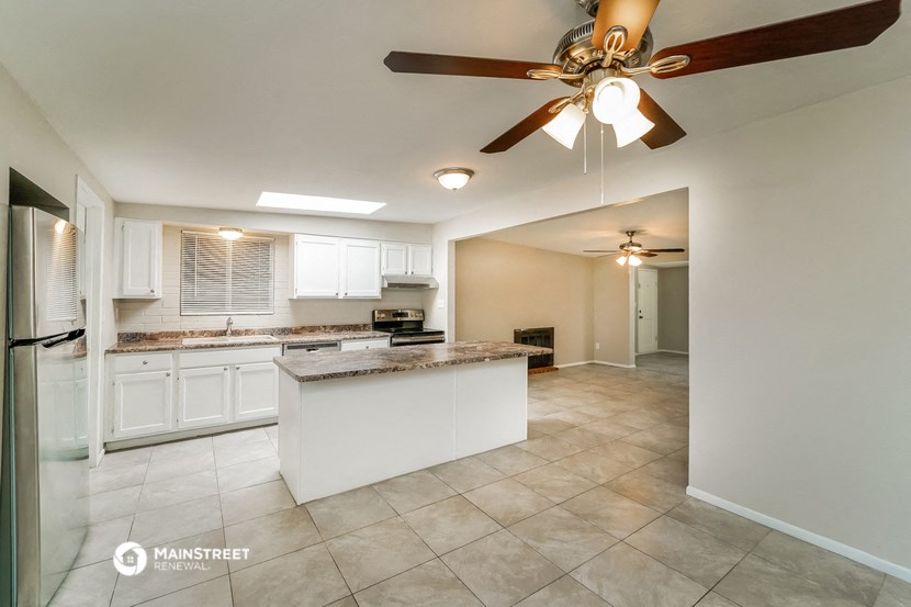the kitchen is open to the dining room and living room