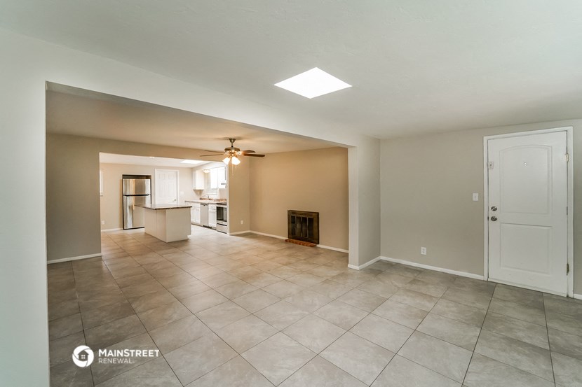 the living room and kitchen are spacious with tile flooring and a fireplace