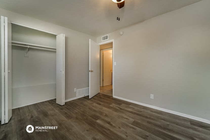 a bedroom with a closet and a door to a hallway