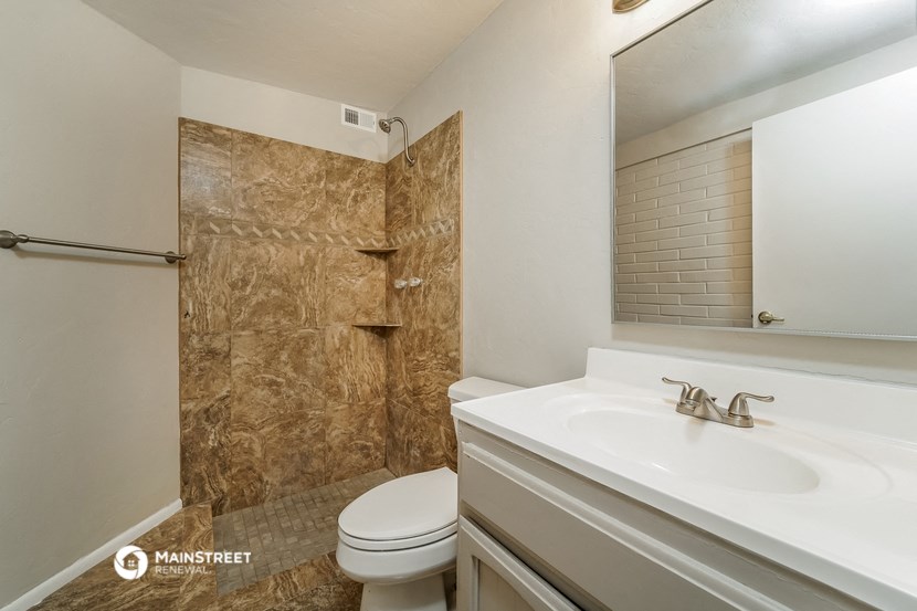 a bathroom with a sink toilet and a shower