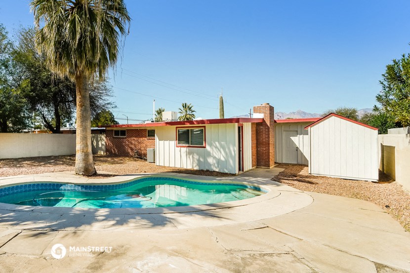 a house with a pool in front of it