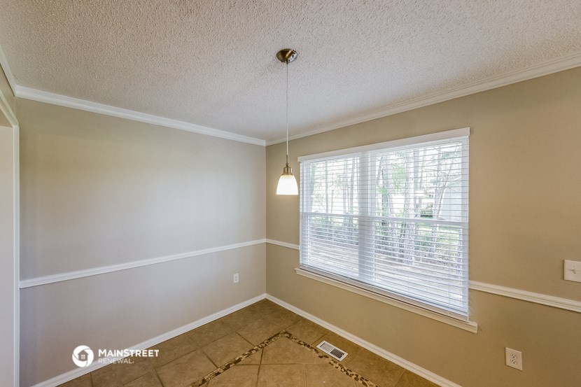the living room of an empty home with a large window