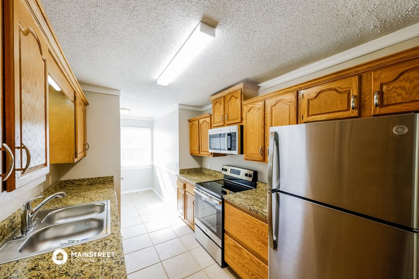 a kitchen with stainless steel appliances and wooden cabinets