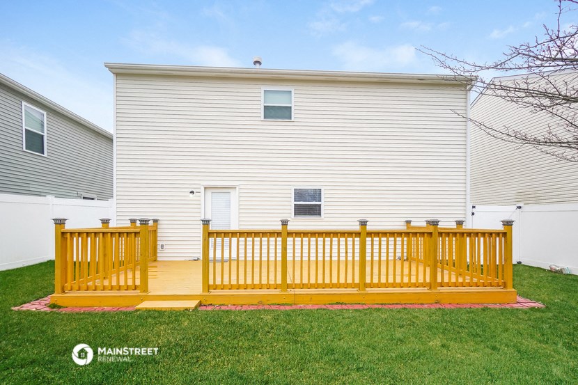 a yellow fence in front of a white house