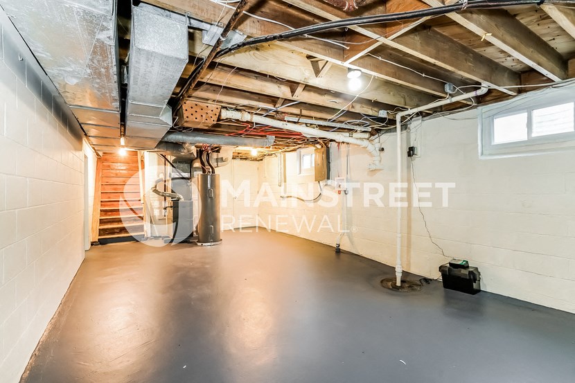 a large garage with a metal floor and white walls