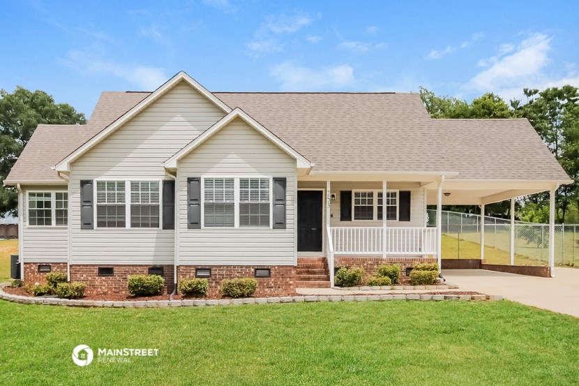 a white house with a yard and a fence