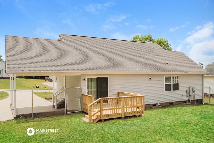 a white house with a porch and a deck