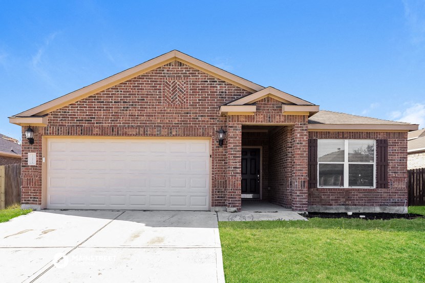 a brick house with a white garage door