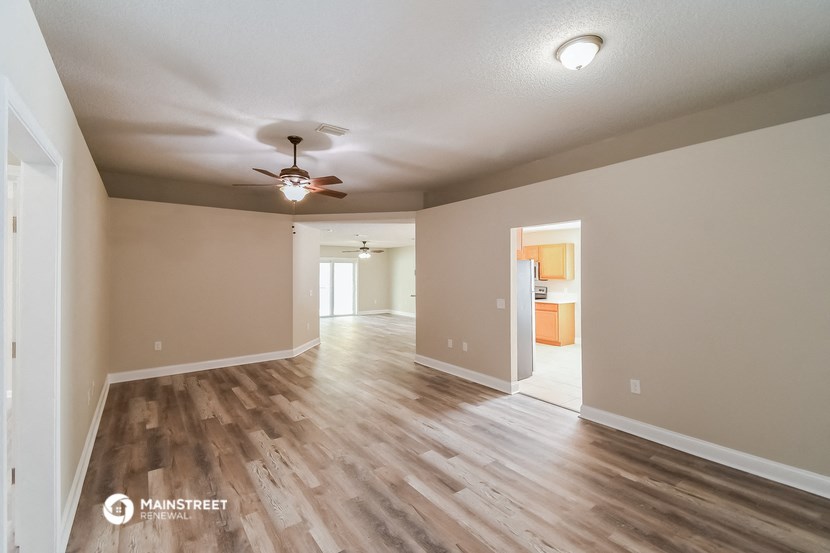 the spacious living room and dining room with hardwood flooring