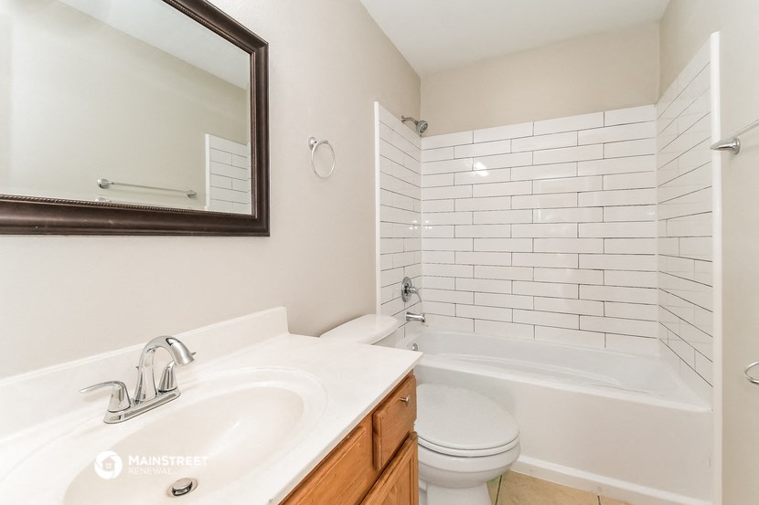 a bathroom with a sink and a toilet and a tub