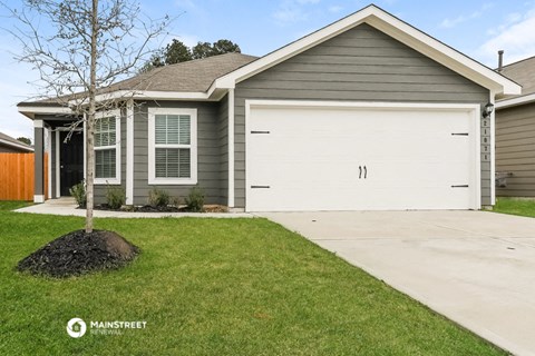 a home with a white garage door and a driveway