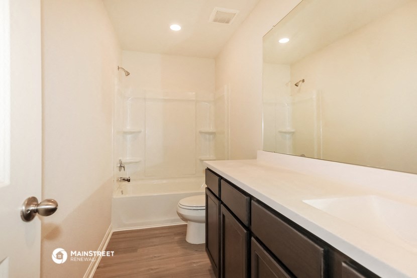 a bathroom with a sink and a toilet and a shower