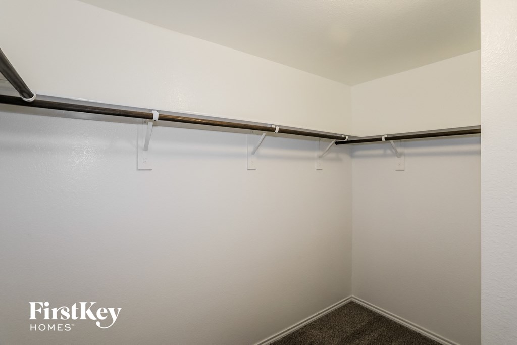 A room with a white wall and a grey floor.