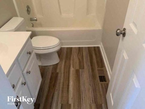 a bathroom with a toilet and a bath tub