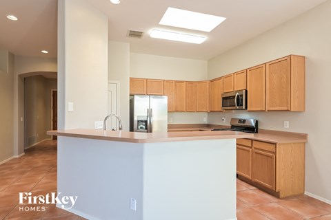 a kitchen with wooden cabinets and a white counter top