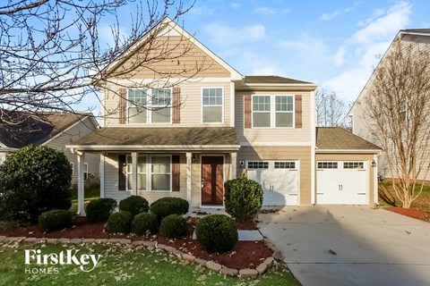 a house with a driveway and a white garage door