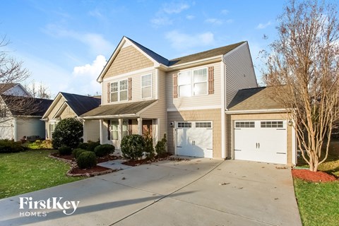 a beige house with a white garage door