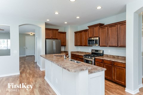 a kitchen with wooden cabinets and granite counter tops