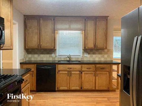 a kitchen with wooden cabinets and stainless steel appliances