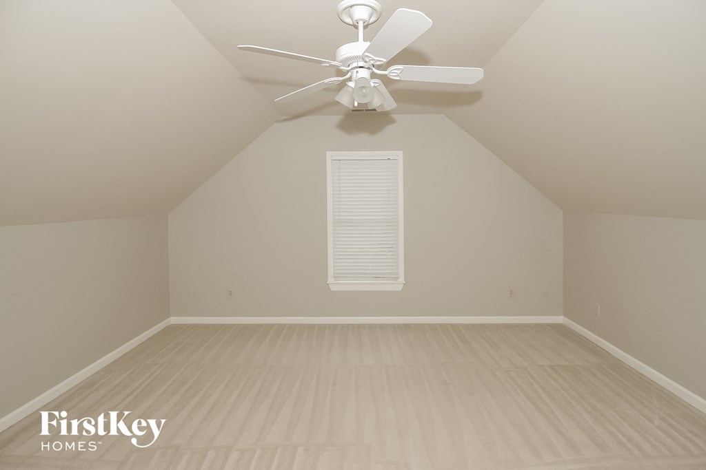 the attic of a home with a ceiling fan