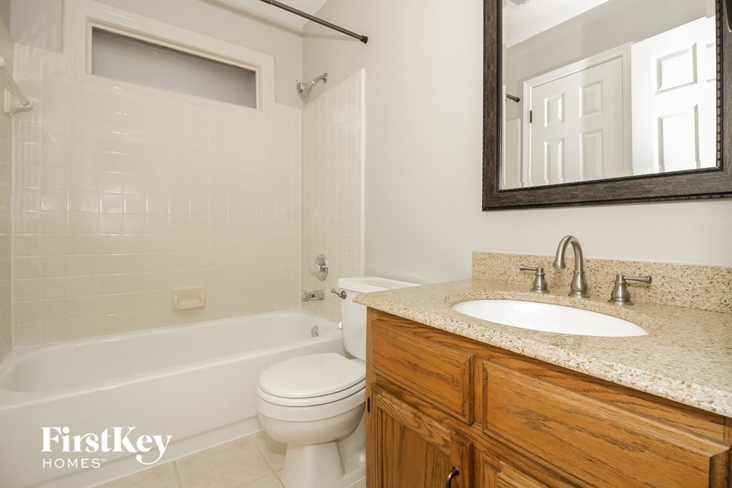 a bathroom with a toilet and a sink and a bath tub