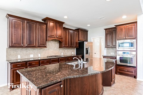 a kitchen with wood cabinets and granite counter tops