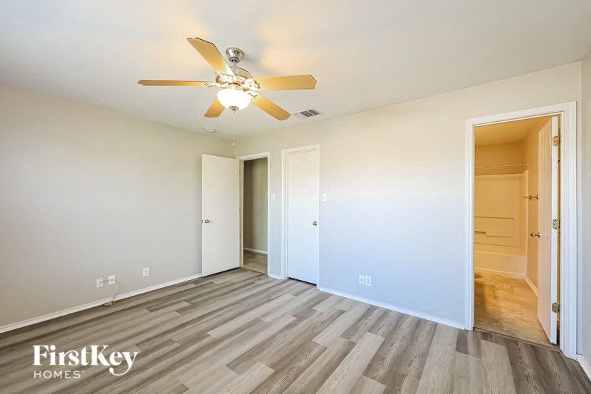 a living room with wood flooring and a ceiling fan