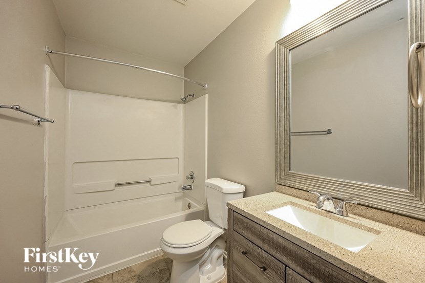 a bathroom with a toilet and a sink and a bath tub
