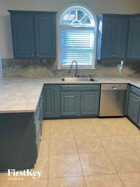 a kitchen with blue cabinets and a sink
