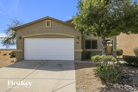a house with a white garage door and a tree