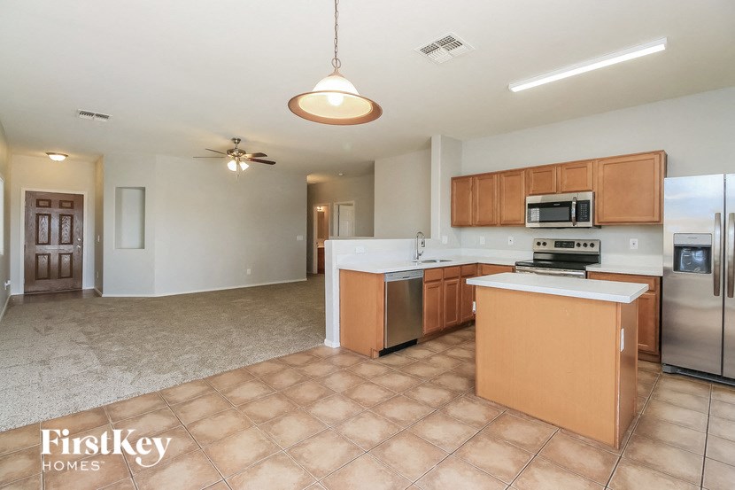a large kitchen with an island and stainless steel appliances