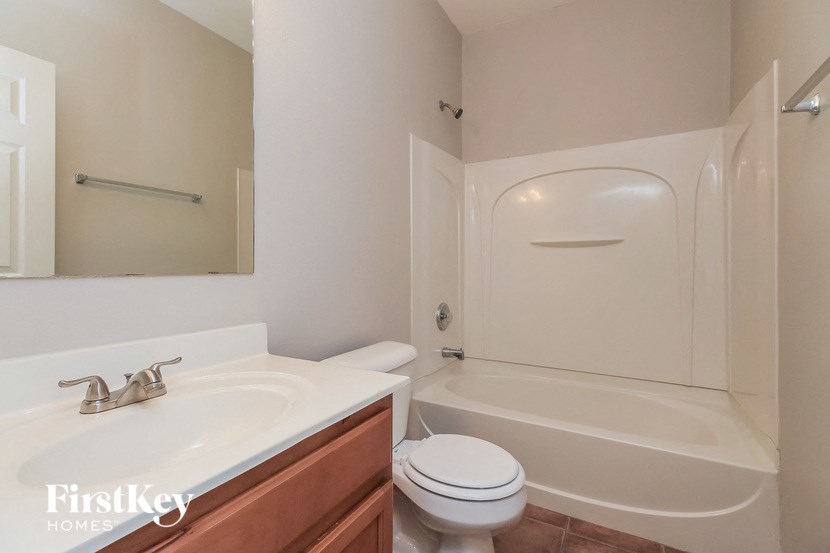 a bathroom with a sink toilet and a bath tub