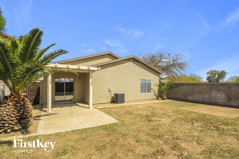 a home with a palm tree and a patio