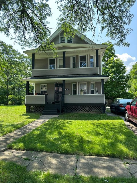 a house with a lawn and a sidewalk