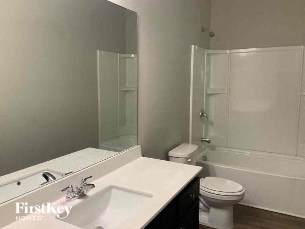 a white bathroom with a sink and a toilet