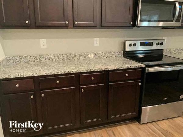a kitchen with a granite counter top and a stove