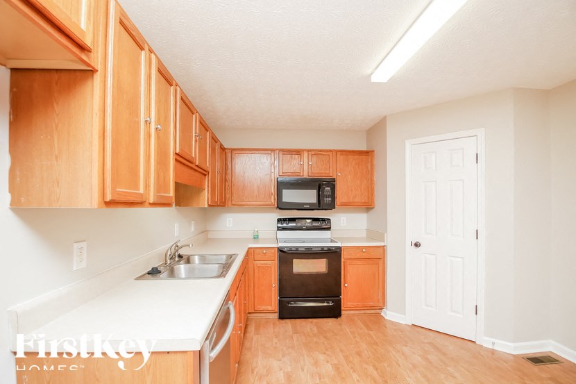 a kitchen with wooden cabinets
