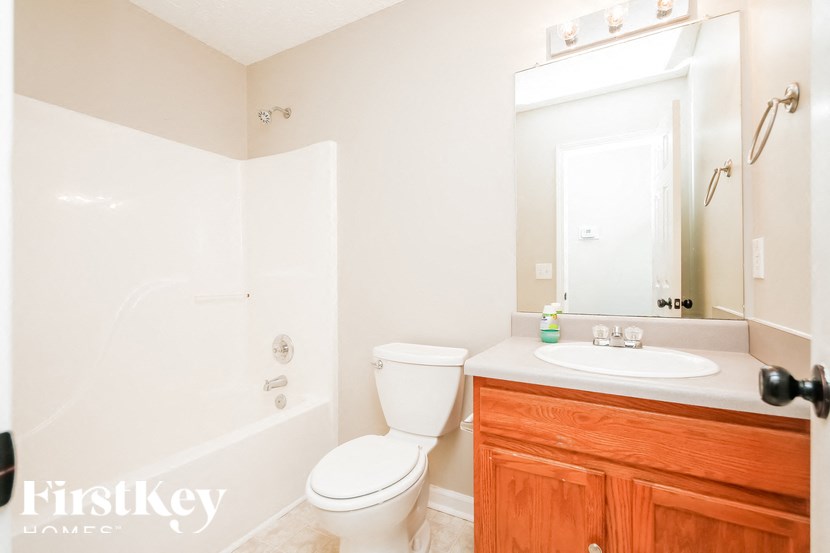 a bathroom with a toilet and a sink and a mirror