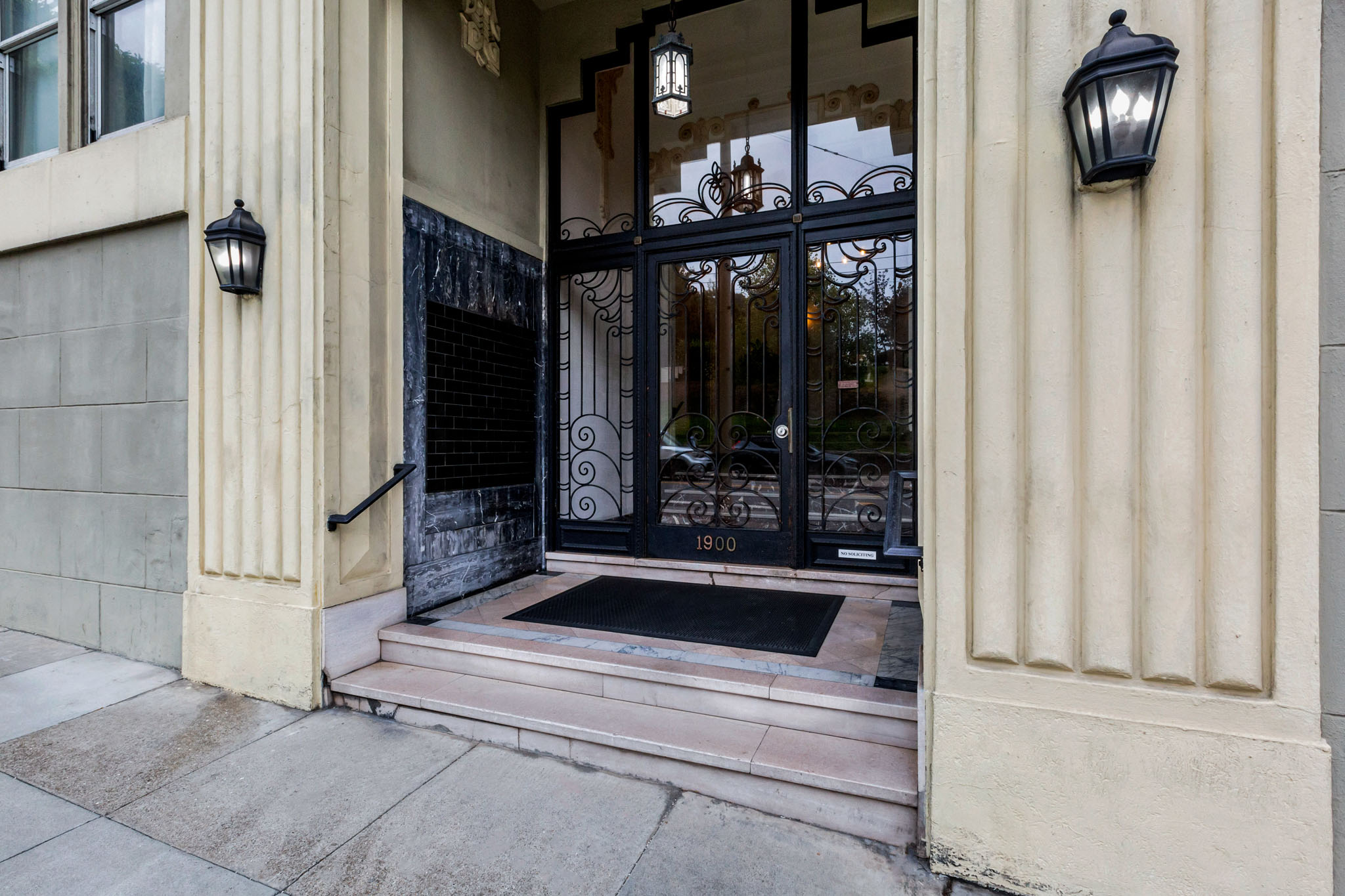 A black wrought iron gate with the number 1900 on it.
