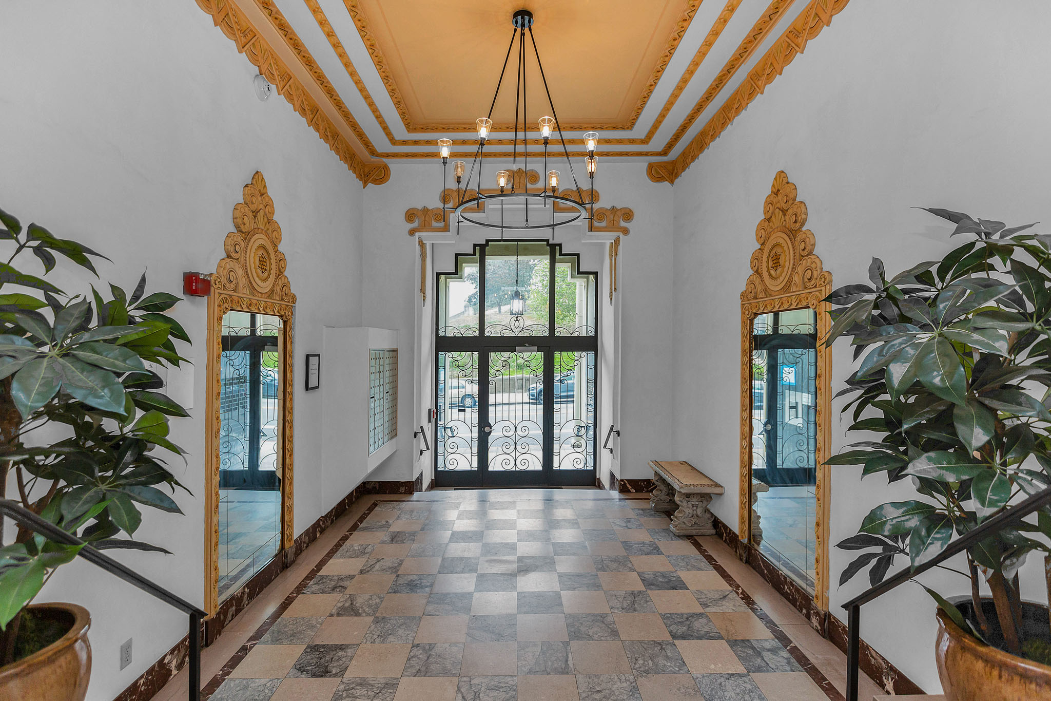A hallway with a checkered floor and a ceiling light.