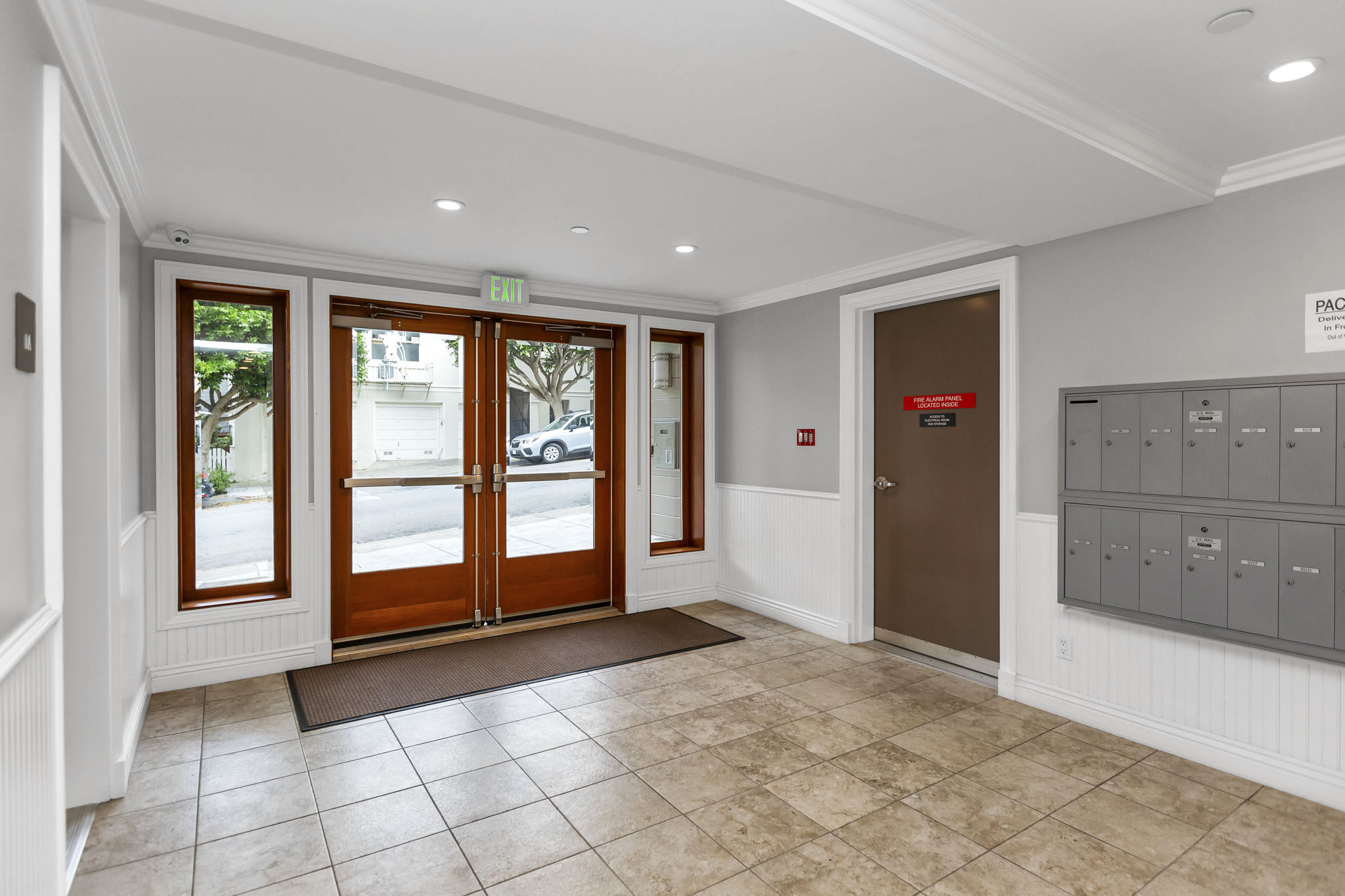 A hallway with a brown door and a sign that says "PAGE".