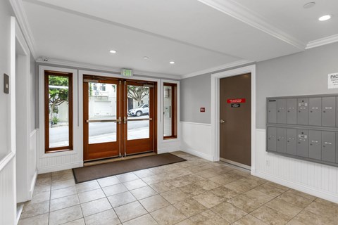 A hallway with a brown door and a sign that says "PAGE".