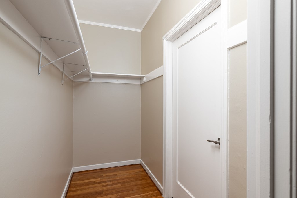 a bedroom with a closet and a white door