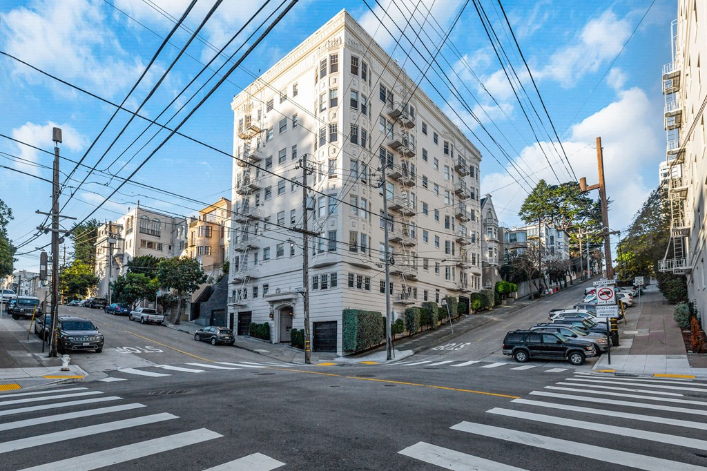 A street view of a city with cars and buildings.