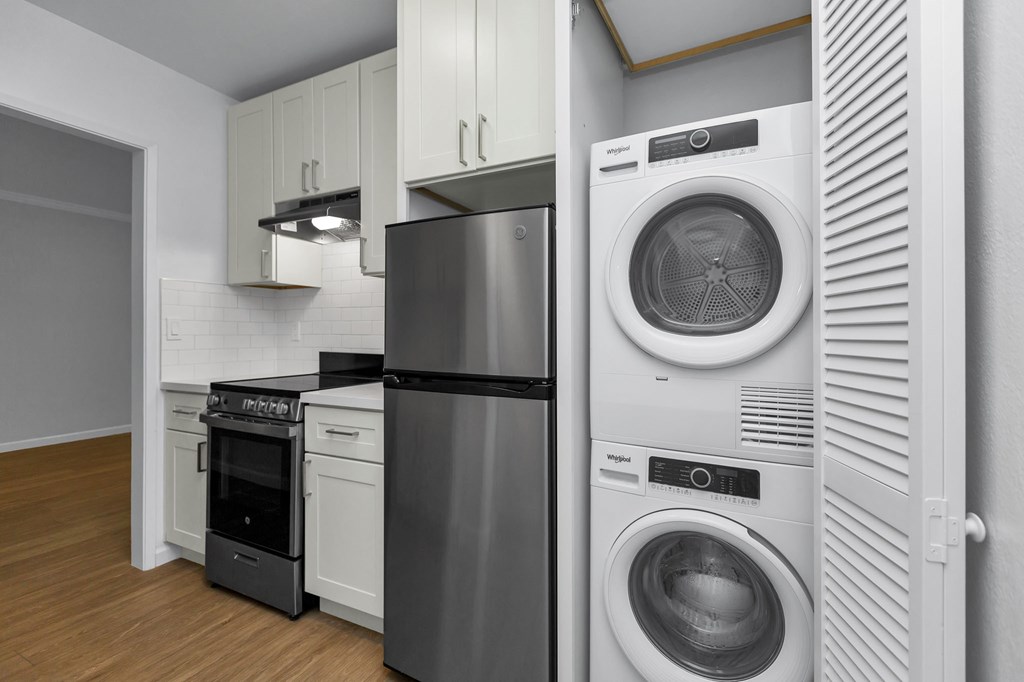 a laundry room with a washing machine and a refrigerator