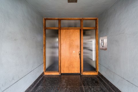 A wooden door with glass panels is closed.