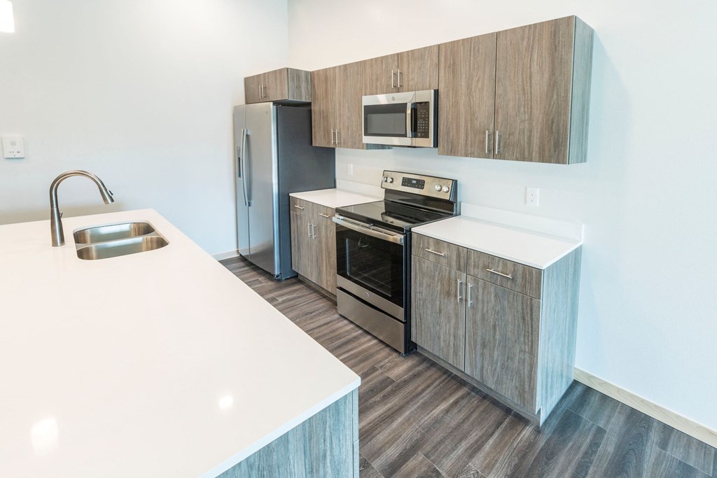 a kitchen with stainless steel appliances and wooden cabinets