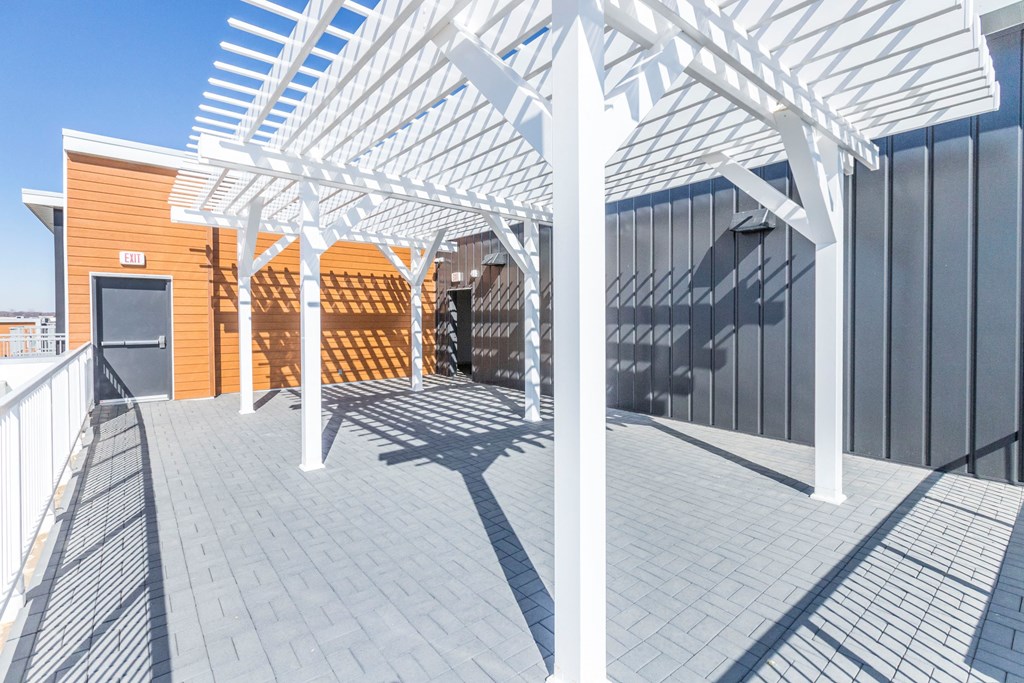 a view of the pergola on the roof of a building