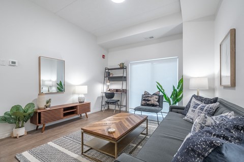a living room with a gray couch and a coffee table